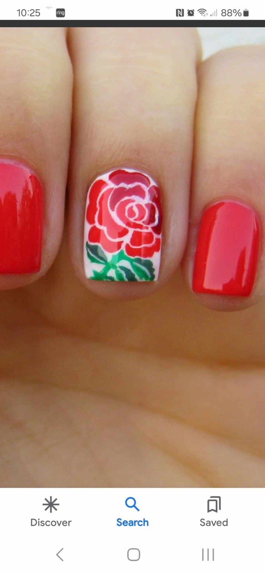 Short red gel nails with a hand-painted rose accent nail